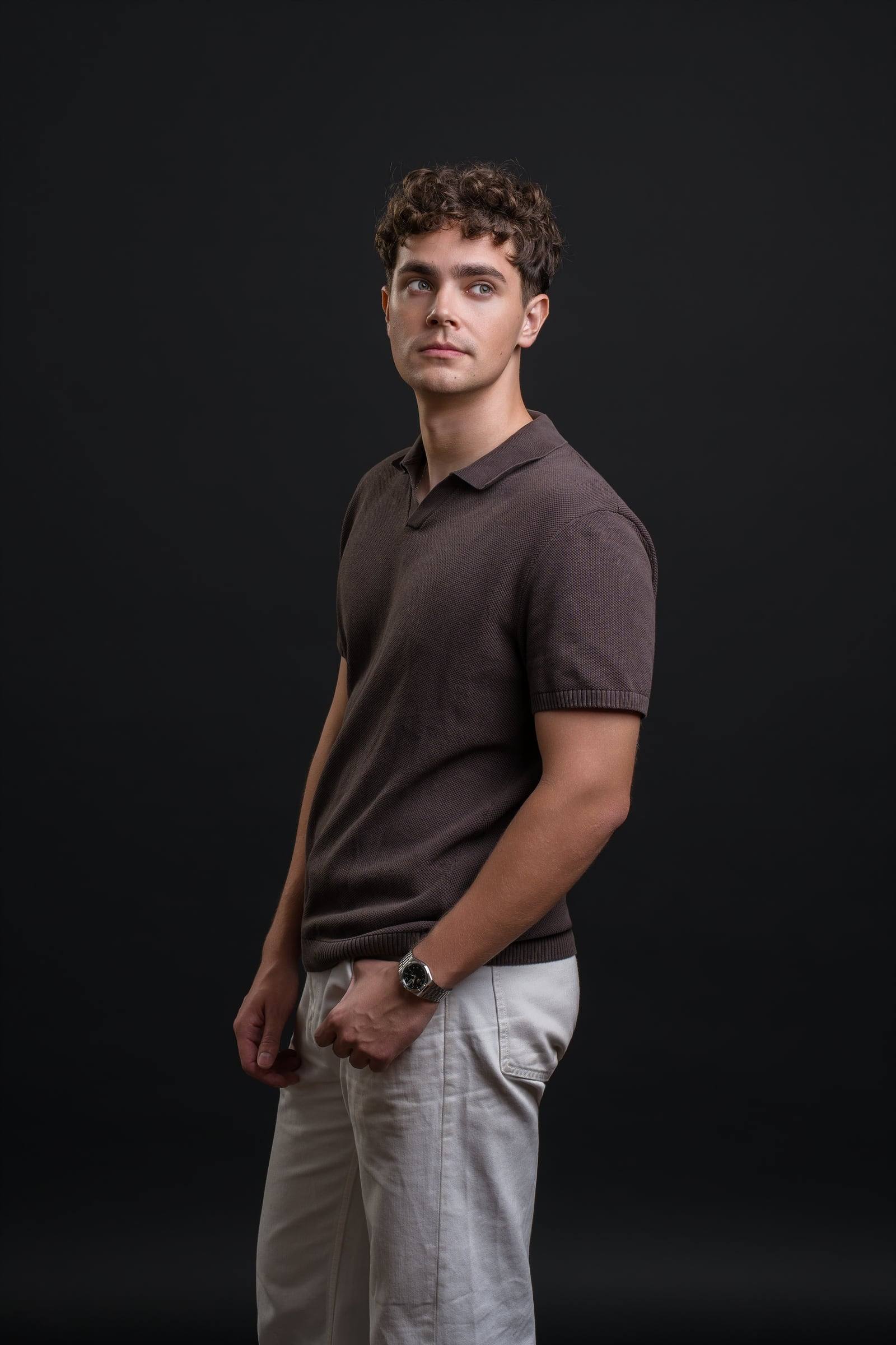 Jorge Tyrakowski in a brown knit polo and light trousers, three-quarter, looking away