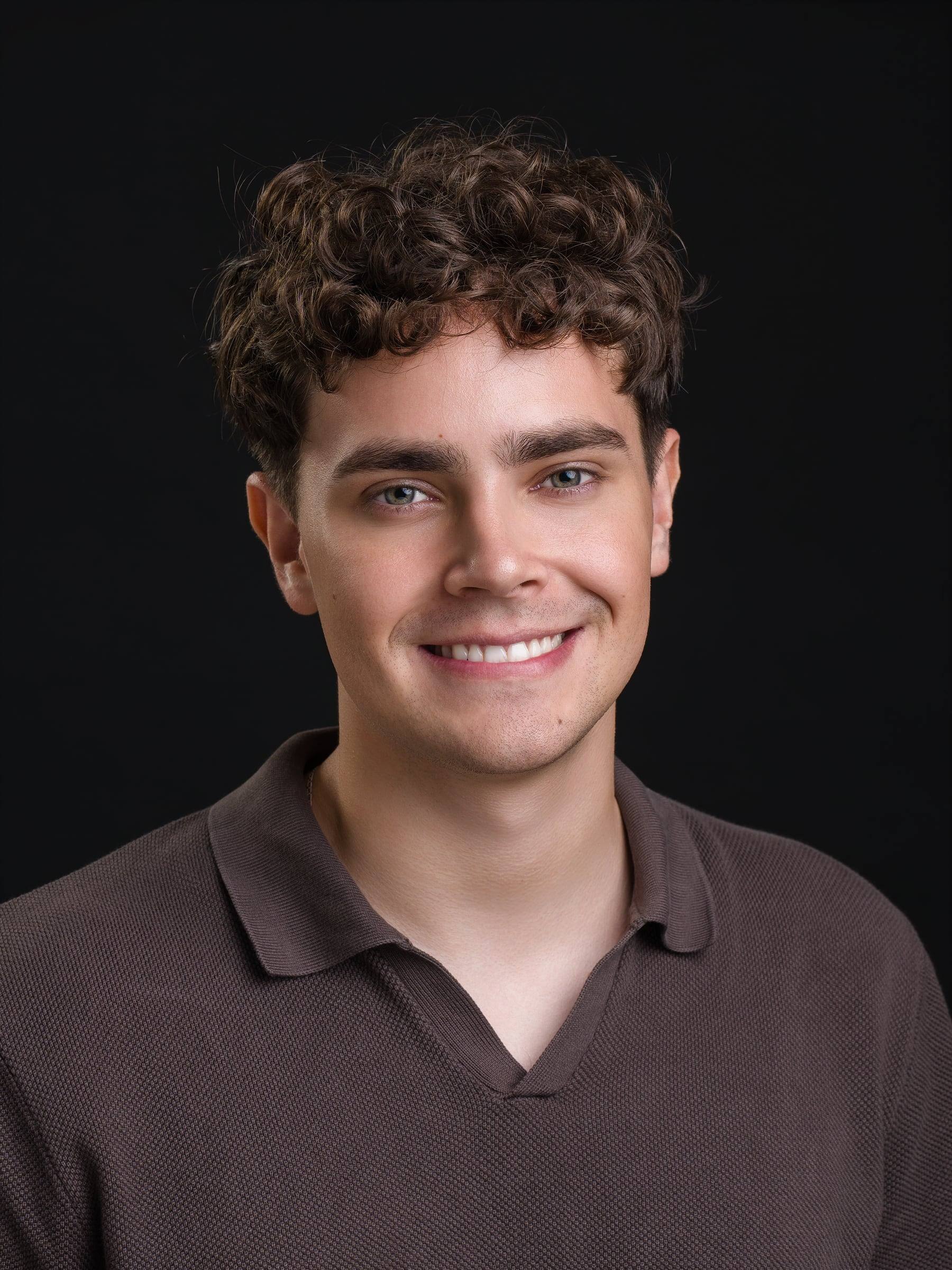 Jorge Tyrakowski in a brown knit polo and light trousers, smiling headshot